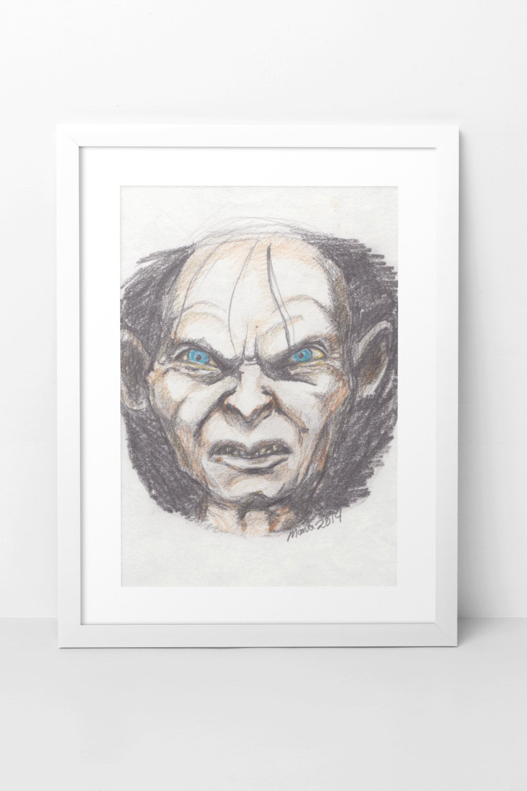 Pencil and color pencil drawing of Gollum from The Lord of the Rings, featuring menacing blue eyes, a scrunched nose, and a slightly open mouth exposing sharp teeth. His pale face contrasts with the dark background, intensifying his pained and sinister expression. The A5-sized artwork is displayed in a white mock-up frame against a neutral background, highlighting the contrast and eerie atmosphere.