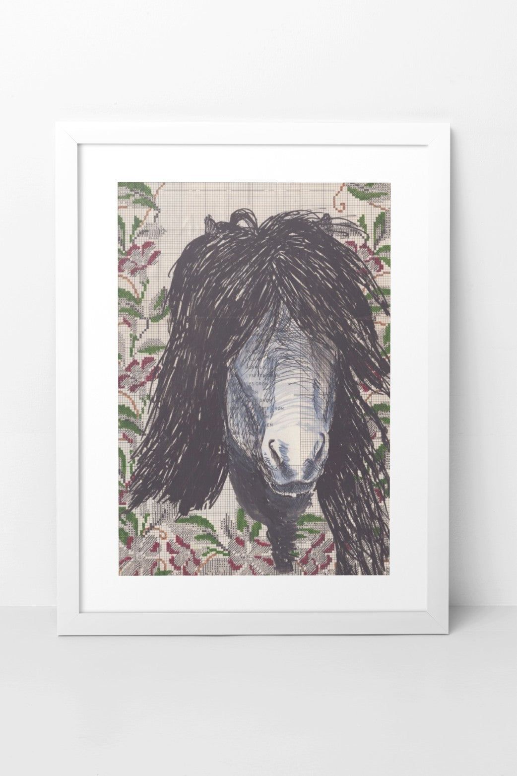 Mixed media artwork in collage and pen, featuring the face of an Icelandic horse with a luscious black mane, intricately drawn with pen. The background includes a printed textile pattern, adding texture and depth to the composition. The A4-sized artwork is displayed in a white mock-up frame against a neutral background, highlighting its detailed pen work and rich textures.
