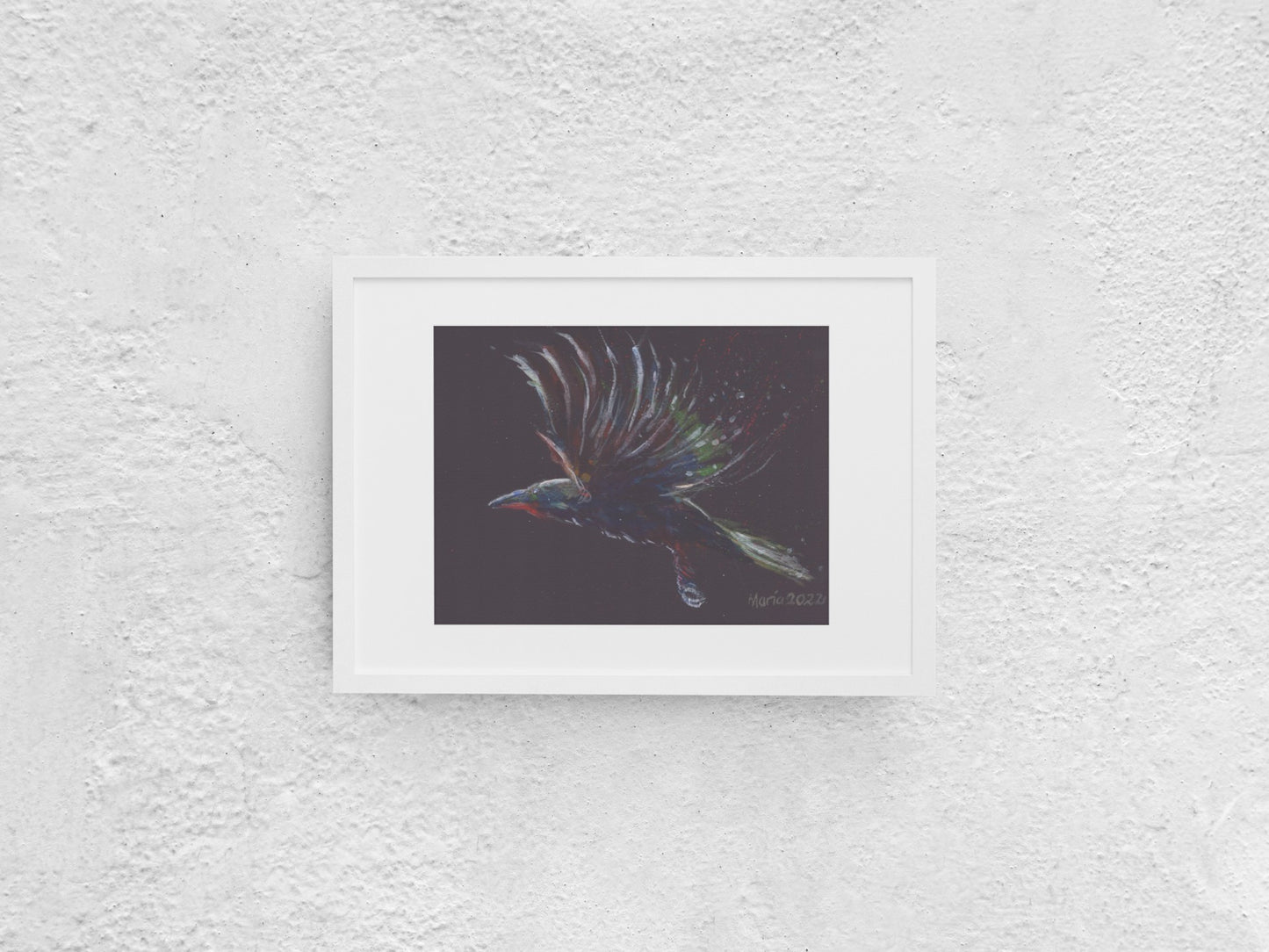 Gouache painting on black watercolor paper depicting a raven in mid-flight, shown in profile view. The bird is colored in soft shades of blue, green, white, and red, gently contrasting against the black background. The A4-sized artwork is displayed in a white mock-up frame against a neutral background, emphasizing its delicate colors and striking composition.