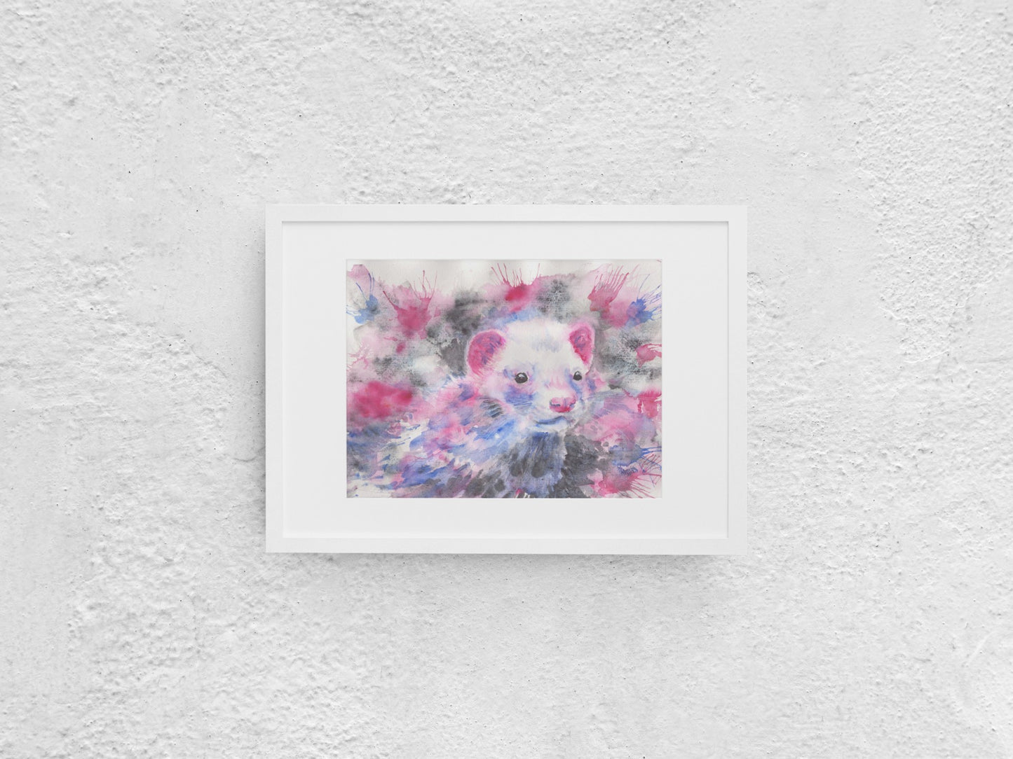 Watercolor painting of an American mink, shown up close, gazing to the right. The mink has white fur on its face, with pink ears, a pink nose, and black eyes. Its fur features hues of pinkish red, blue, and black, with touches of blue and pinkish red on its face. The background mirrors these colors with shades of blue, black, and red. The artwork, slightly smaller than A3, is displayed in a white mock-up frame against a neutral background, highlighting its vibrant colors and intricate detail.