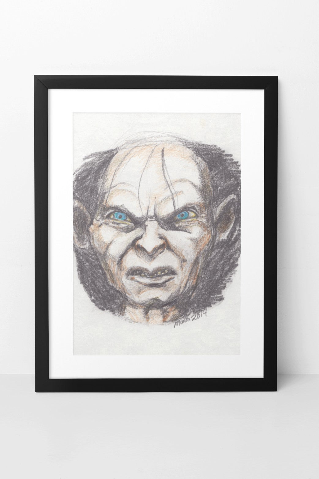 Pencil and color pencil drawing of Gollum from The Lord of the Rings, featuring menacing blue eyes, a scrunched nose, and a slightly open mouth exposing sharp teeth. His pale face contrasts with the dark background, intensifying his pained and sinister expression. The A5-sized artwork is displayed in a black mock-up frame against a neutral background, highlighting the contrast and eerie atmosphere.