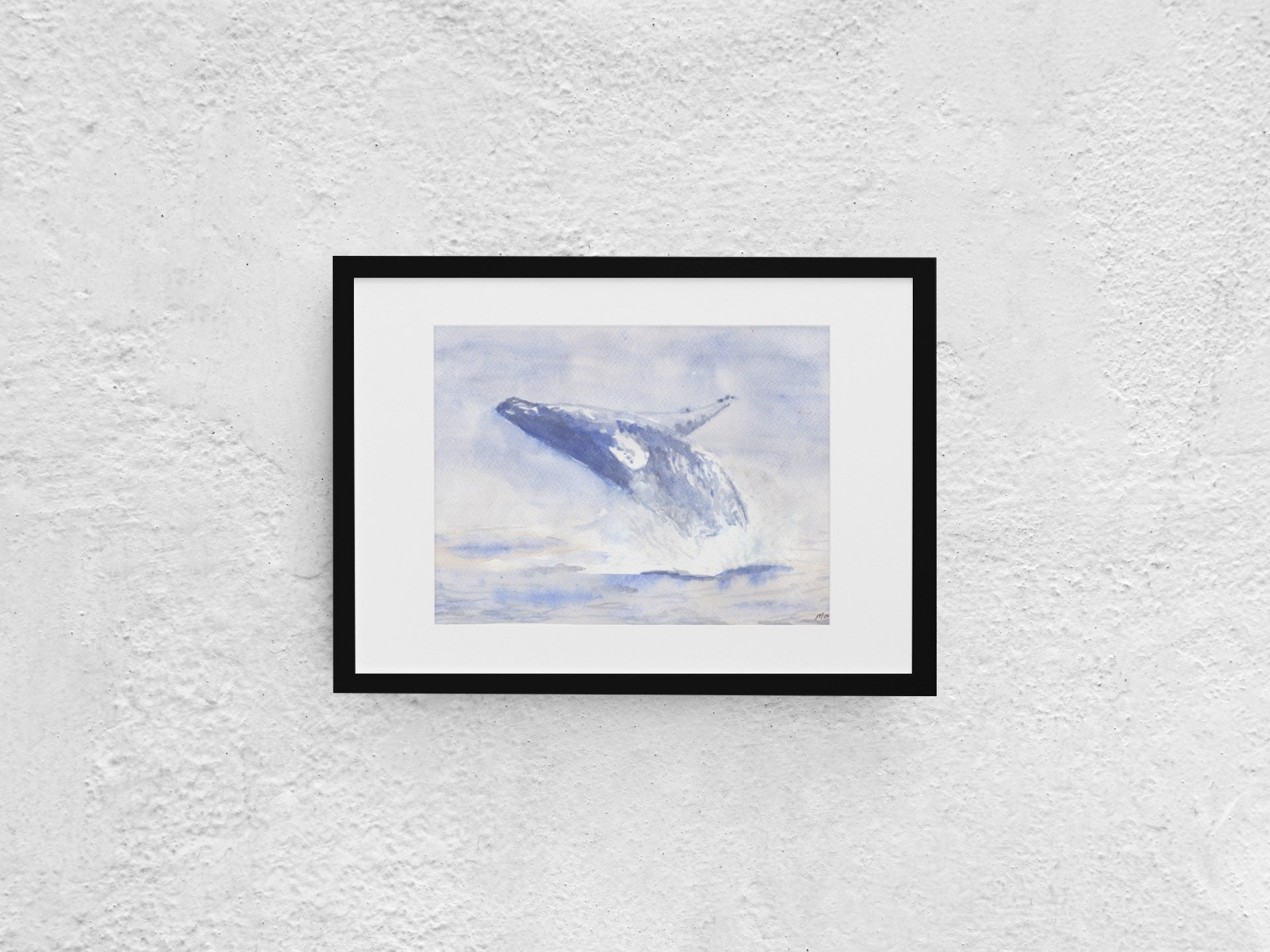 Watercolor painting of a blue whale jumping out of the water, positioned midway with its head toward the sea and belly toward the air. The artwork features soft blue hues contrasting against white, with visible water splashing. The A4-sized artwork is displayed in a black mock-up frame against a neutral background, emphasizing its soft colors and dynamic motion.