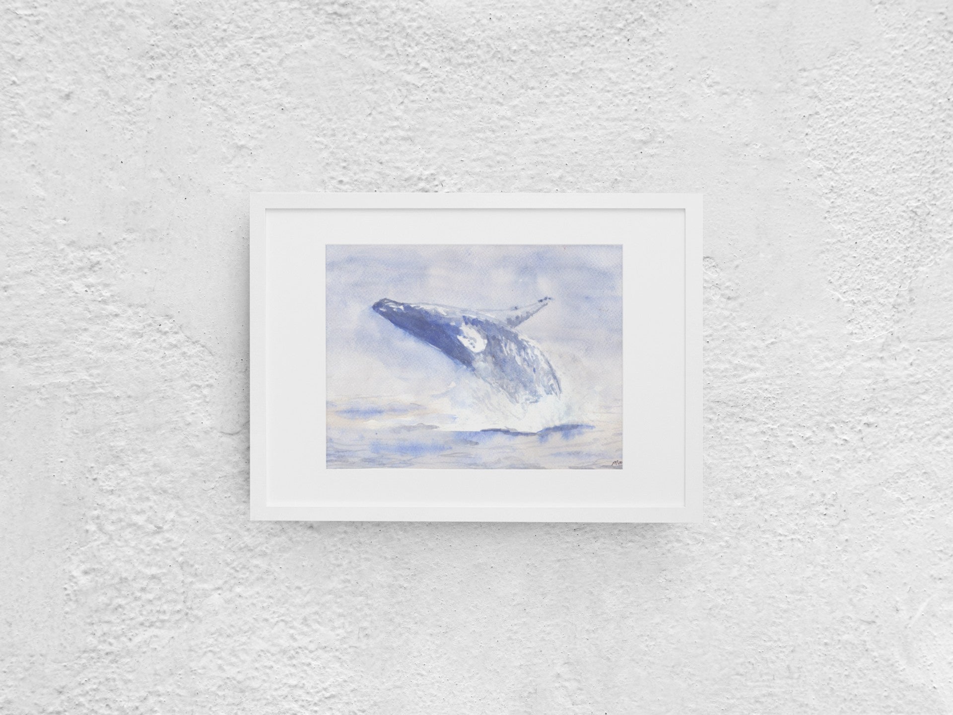 Watercolor painting of a blue whale jumping out of the water, positioned midway with its head toward the sea and belly toward the air. The artwork features soft blue hues contrasting against white, with visible water splashing. The A4-sized artwork is displayed in a white mock-up frame against a neutral background, emphasizing its soft colors and dynamic motion.