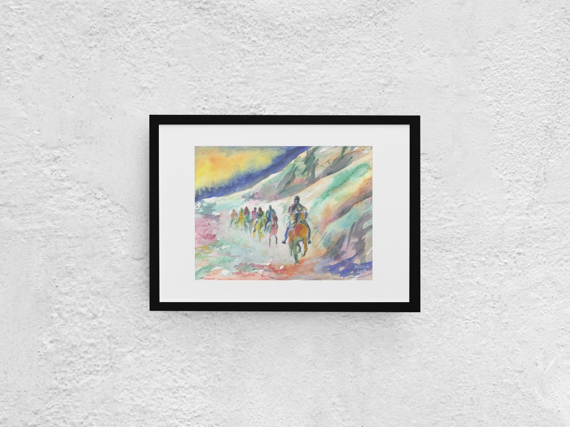 A vibrant painting depicting a group of people on a horseback riding trip beneath a towering mountainous cliff. The painting showcases a variety of hues, including grey, green, orange, red, pink, and white. The sky behind them is split into strong blue and yellow tones, adding dramatic contrast to the scene. The A4-sized artwork is displayed in a black mock-up frame against a neutral background, emphasizing its dynamic use of color and landscape.
