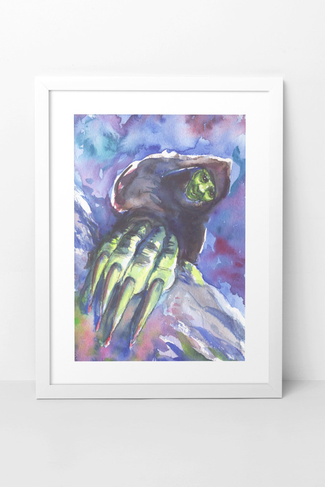 Watercolor painting of Grýla shown up close, with her hand featuring large claws even closer, as if she is climbing up toward the viewer. Her shadowy figure is contrasted by her green face and hand, which are highlighted. Grýla has a nefarious smile on her face. The background is filled with contrasting white, blue, and purple tones that stand out against the green and black elements of her figure. The A4-sized artwork is displayed in a white mock-up frame against a neutral background.