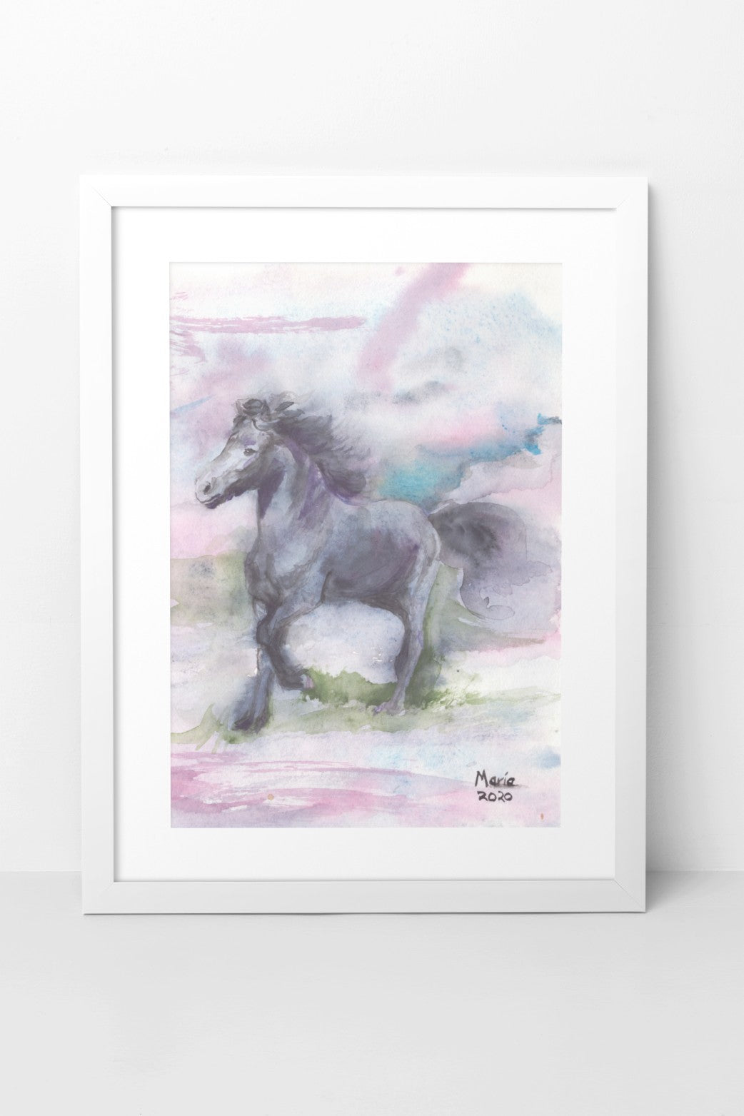 Watercolor painting of an Icelandic horse named Manni, trotting and frolicking on green grass, moving to the left. Manni is black with a matching black mane. The background features soft shades of pink, blue, and green, creating a gentle and serene scene. The A4-sized artwork is displayed in a white mock-up frame against a neutral background, highlighting its soft colors and playful mood.