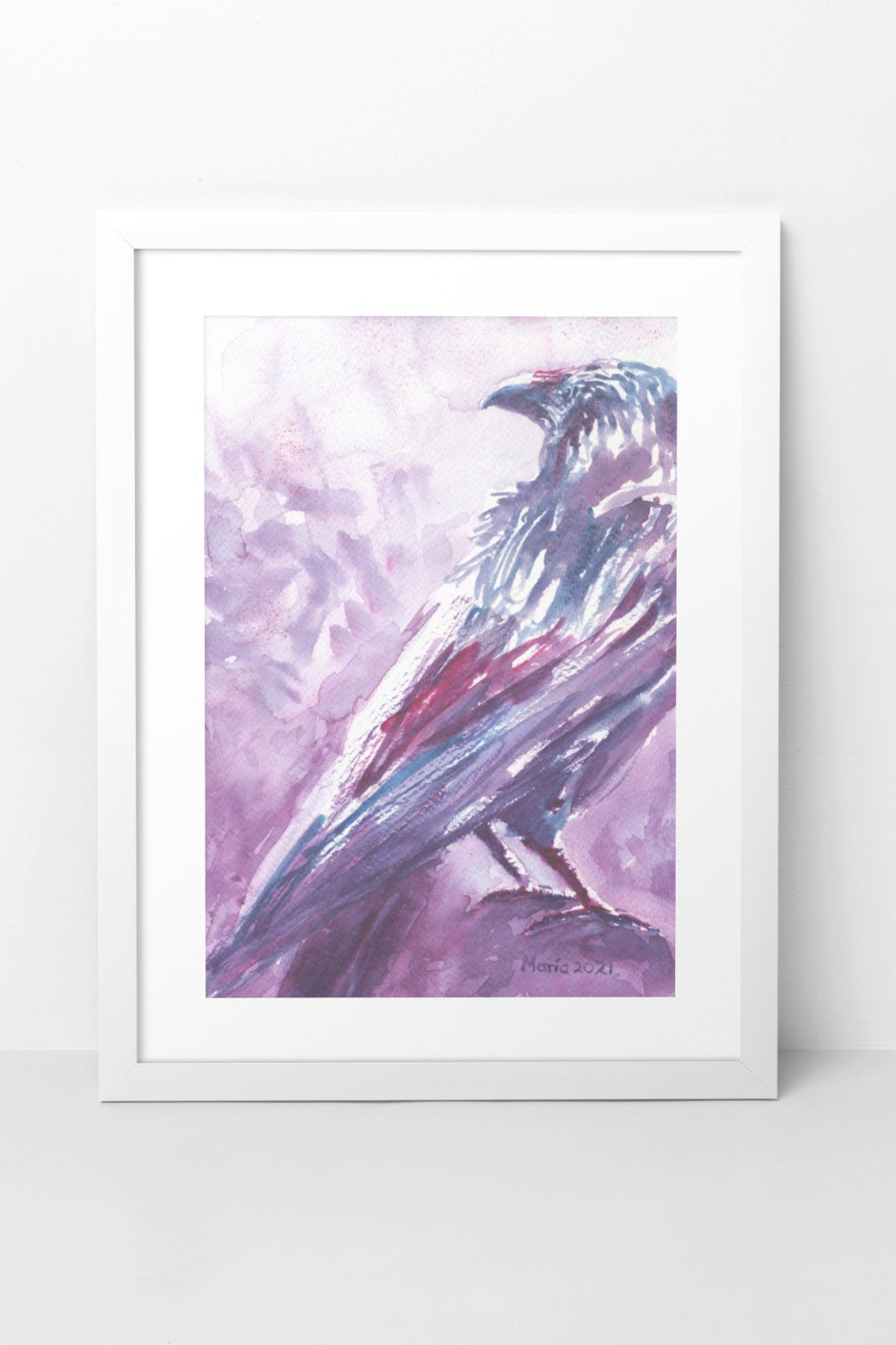 Watercolor painting of a raven resting on a perch, shown from the back with its head turned to the side. The A4-sized artwork is framed in a white mock-up frame against a white wall background. The raven is depicted in dark, soft shades of purple, red, and blue, adding a mysterious and contemplative mood to the piece.