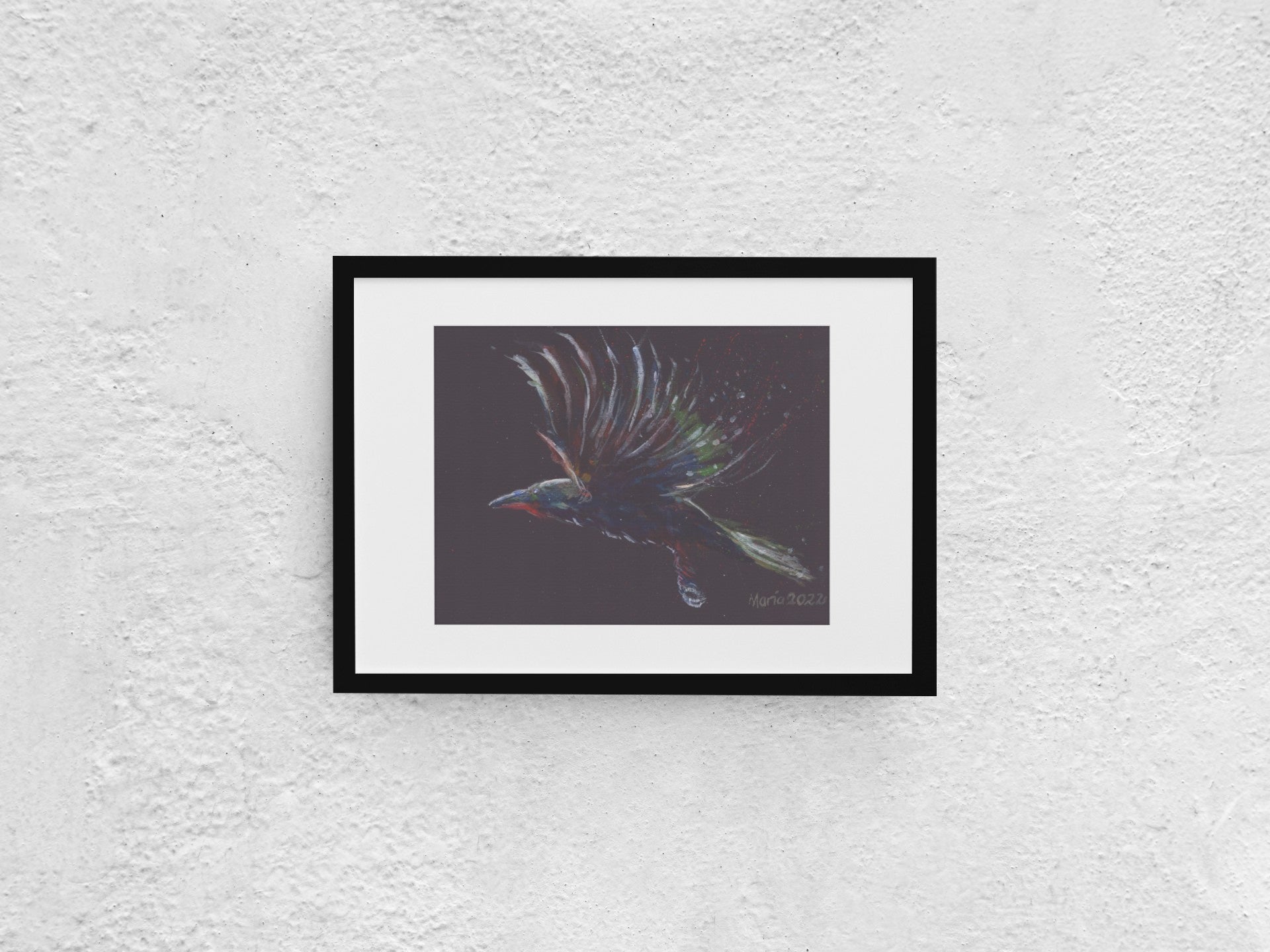 Gouache painting on black watercolor paper depicting a raven in mid-flight, shown in profile view. The bird is colored in soft shades of blue, green, white, and red, gently contrasting against the black background. The A4-sized artwork is displayed in a black mock-up frame against a neutral background, emphasizing its delicate colors and striking composition.