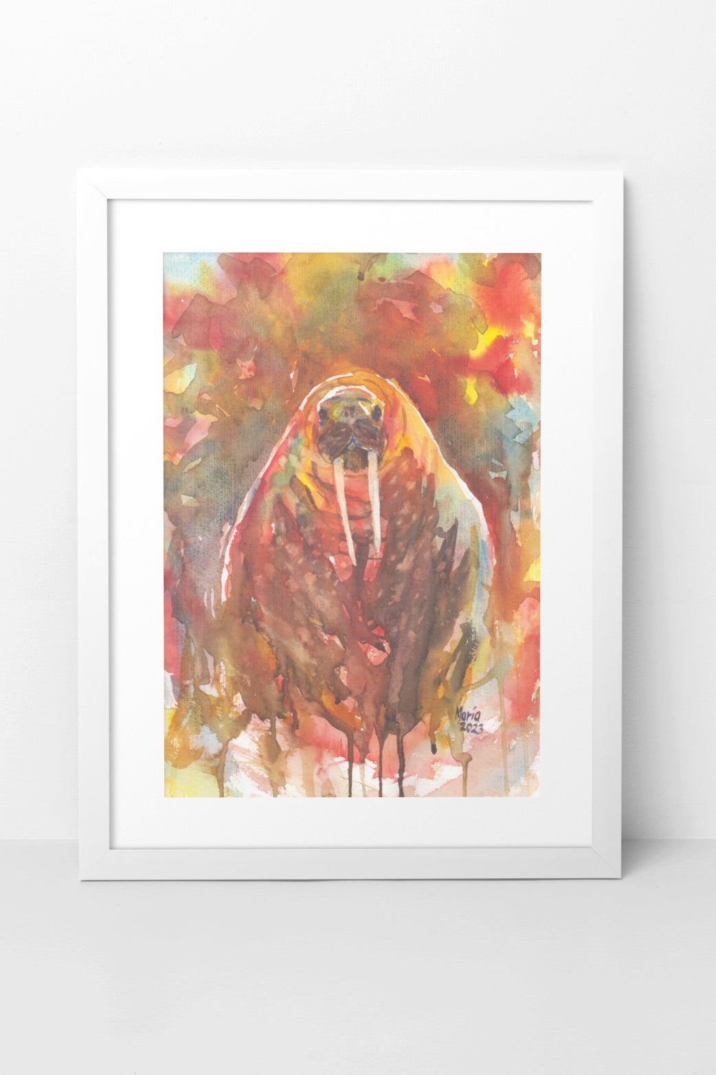 Watercolor painting of a walrus in earthy tones, depicted from the front. Both the walrus and the background feature hues of brown, red, yellow, green, blue, and white. The scene gives the impression of the walrus either peeking up from the water or walking on land. The A3-sized artwork is displayed in a white mock-up frame against a neutral background, highlighting the vibrant earthy tones and composition.